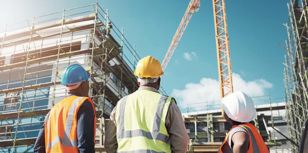 Shot of a group of builders assessing progress at a infrastructure construction site.