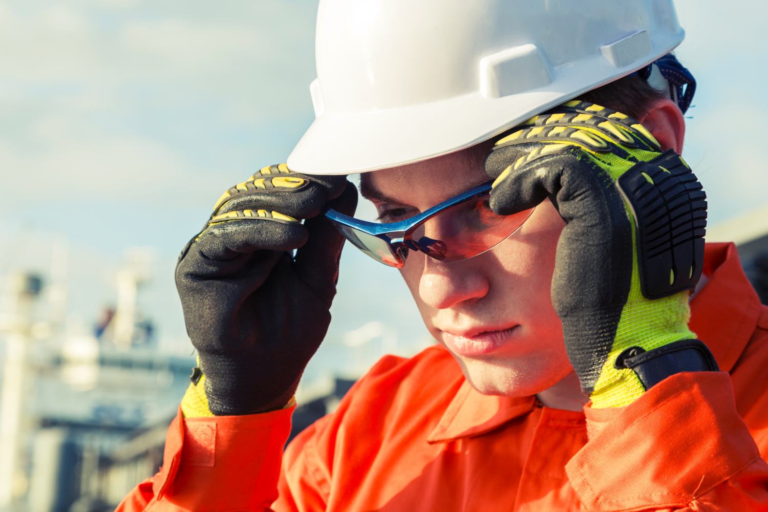 A Construction Worker Putting On Safety Glasses | Hazard Assessment
