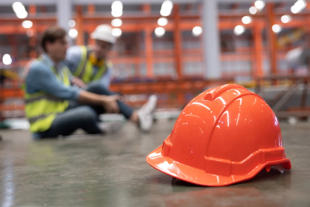 Canadian construction worker adjusting fall protection harness on job site