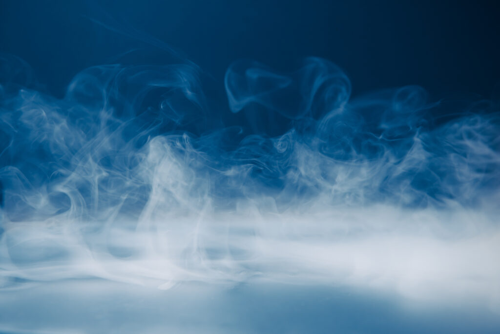 Illustration showing invisible gas particles being inhaled, representing unseen workplace gas hazards.