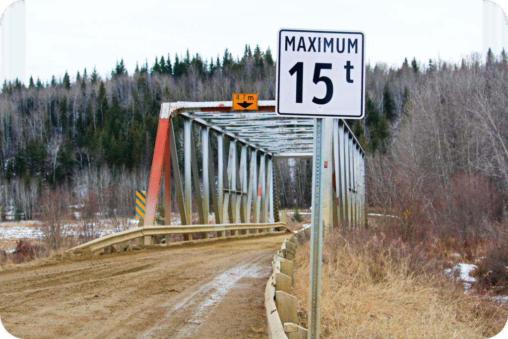 Bridge with posted height limit sign, highlighting the importance of vehicle dimension awareness.