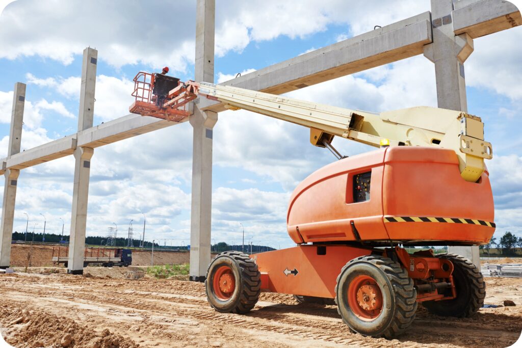 Operator conducts job at height inside facility using mobile elevated work platform and PPE.