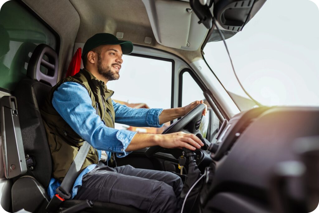 Long-haul truck driver behind the wheel, supporting safe scheduling and compliant driving practices in Canada.