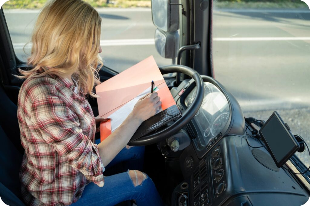 Driver logging work and rest hours manually to maintain off-duty requirements under Canada’s HOS rules.